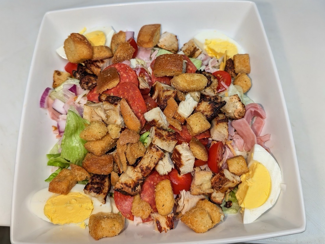 The Water Street Deli Salad with ham, turkey, pepperoni, cheeses, tomatoes, eggs and croutons